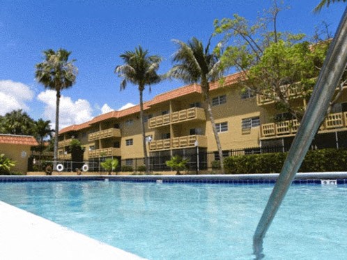 a large swimming pool in front of a building