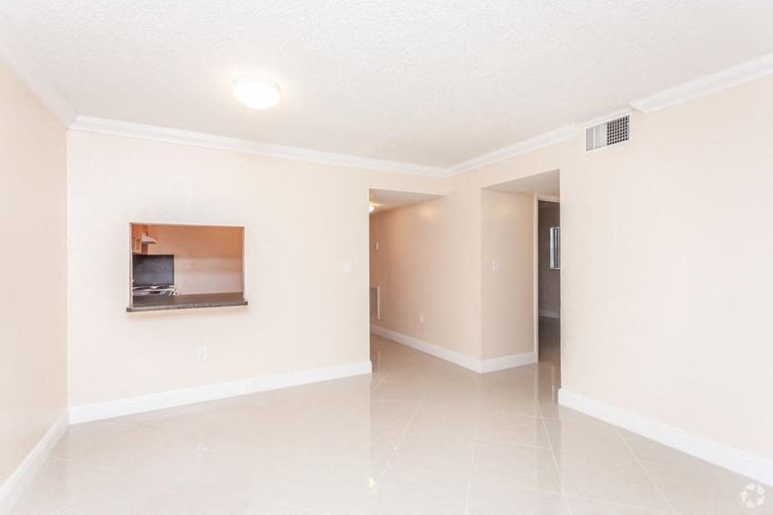 an empty living room with a fireplace
