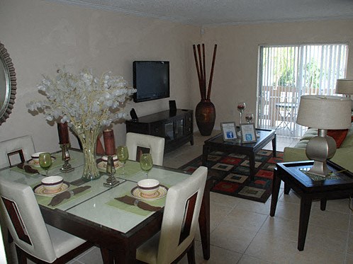a living room with a dining table and a television