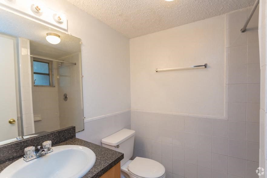 a bathroom with a sink toilet and a mirror