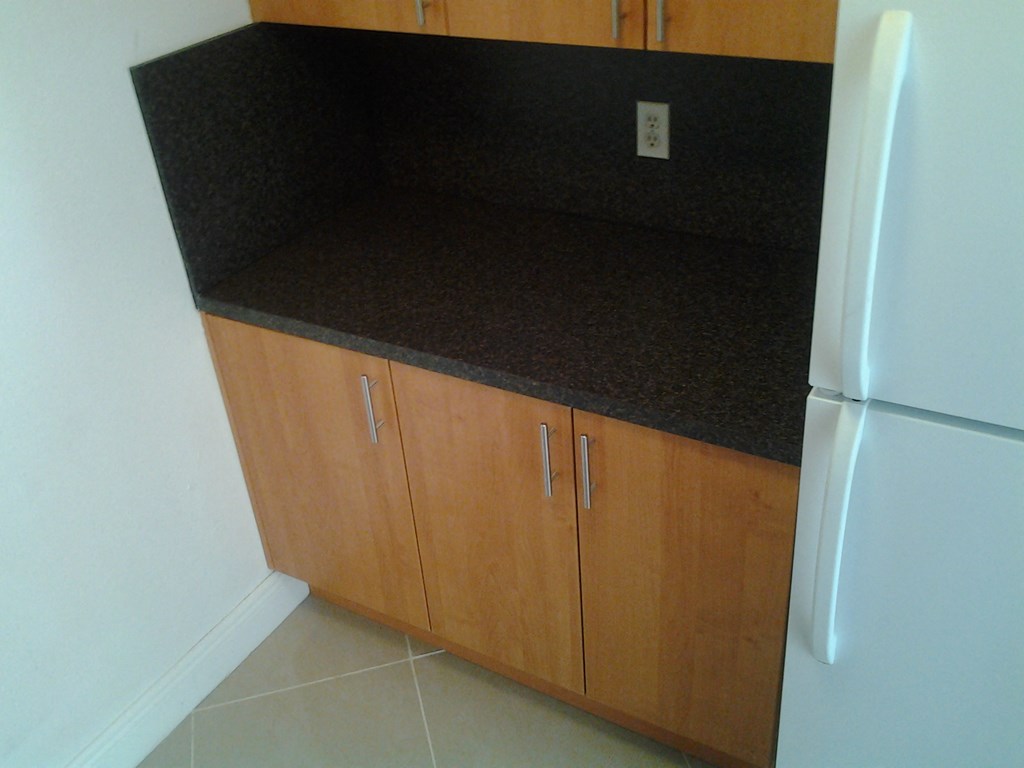 a kitchen with a counter top and a refrigerator