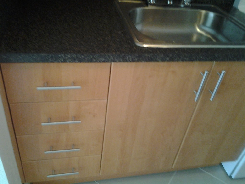 a kitchen with wooden cabinets and a sink