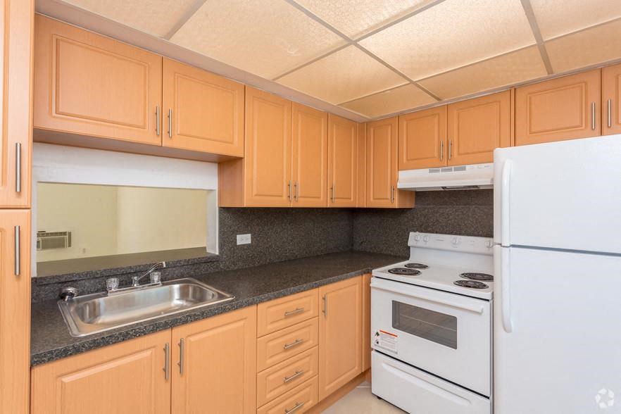 a kitchen with white appliances and wooden cabinets