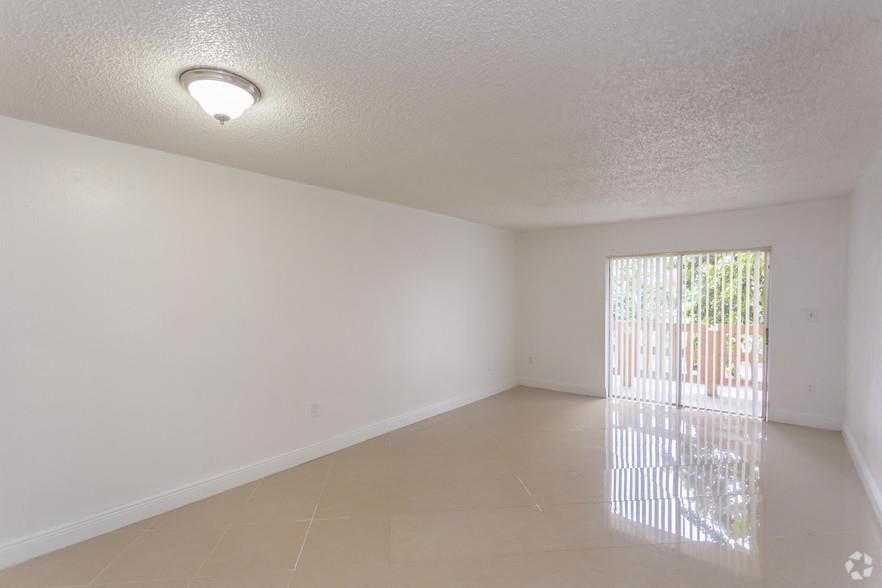 an empty living room with a sliding glass door