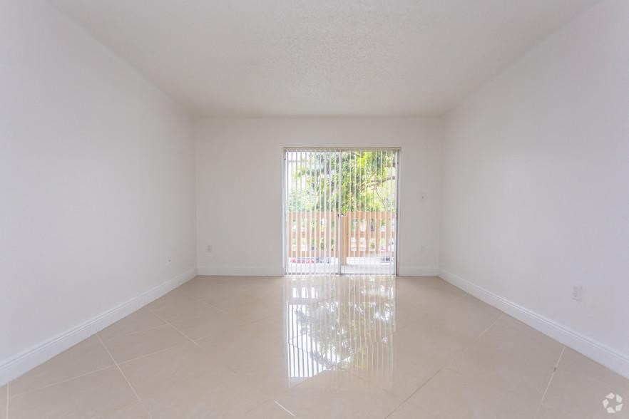 an empty living room with a sliding glass door