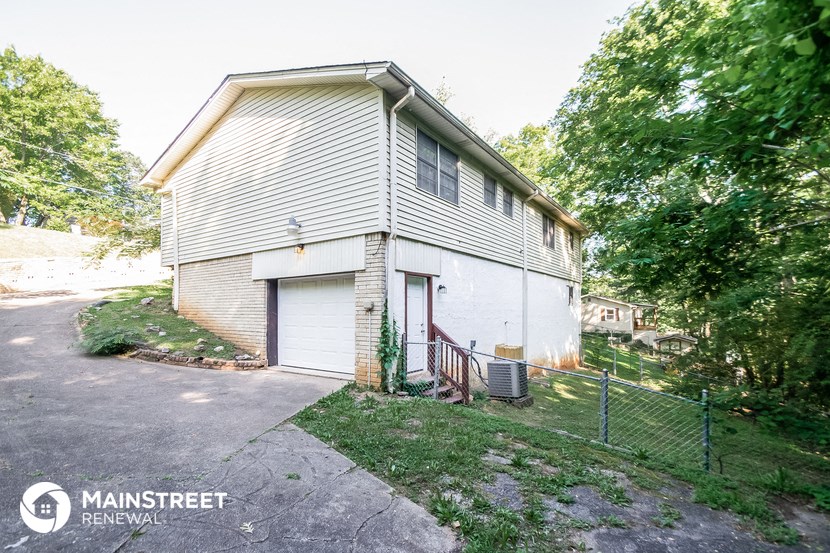 a white house with a yard and a fence