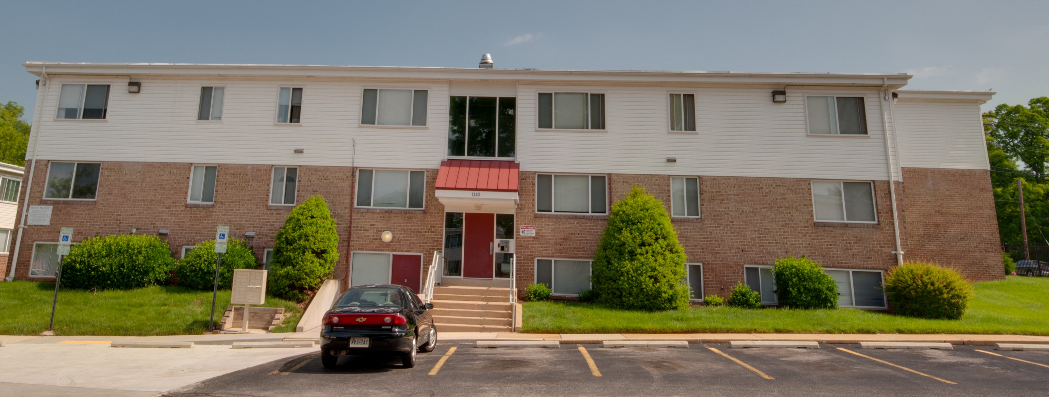 a car parked in front of an apartment building