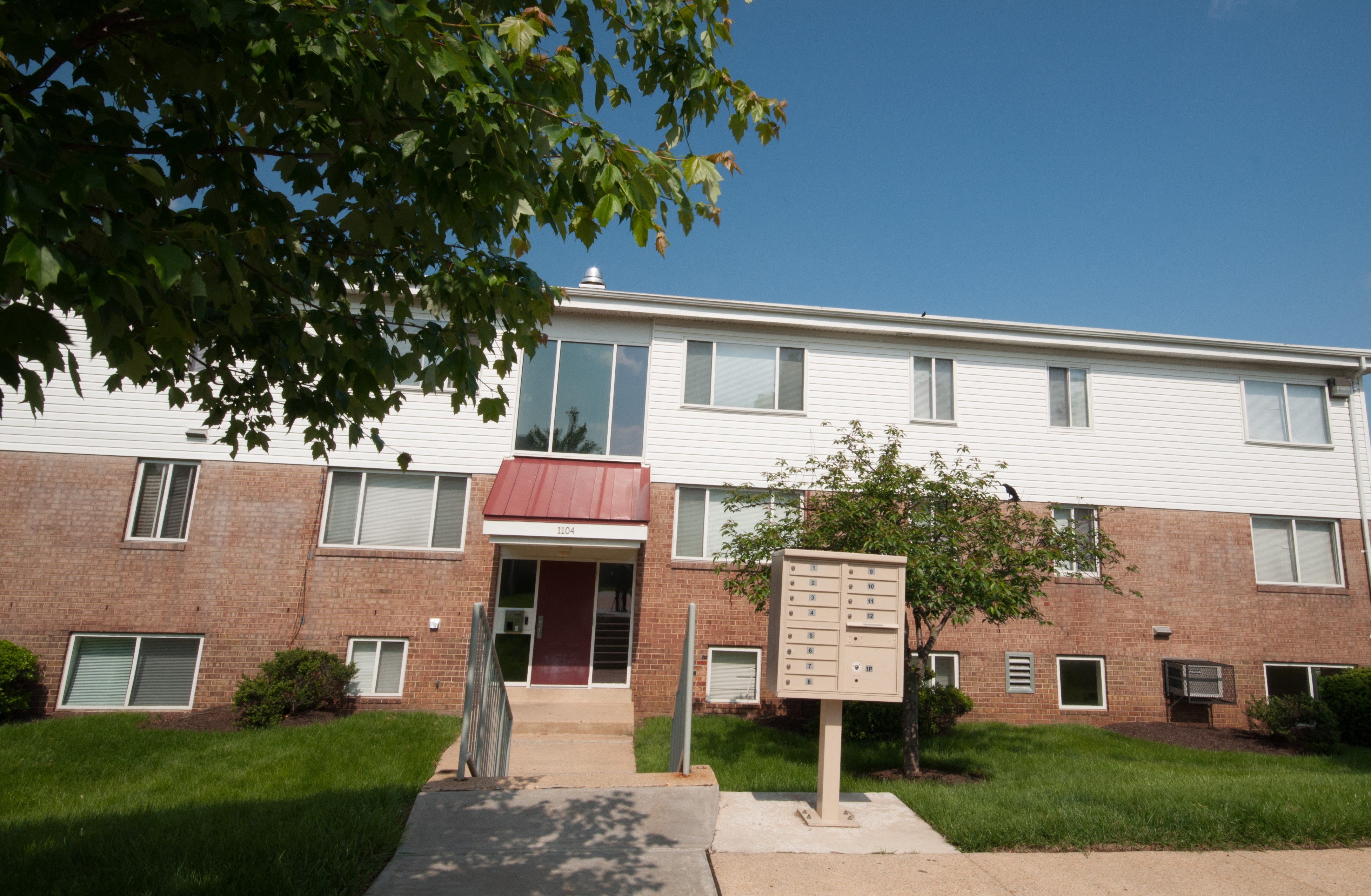 a brick building with a sign in front of it