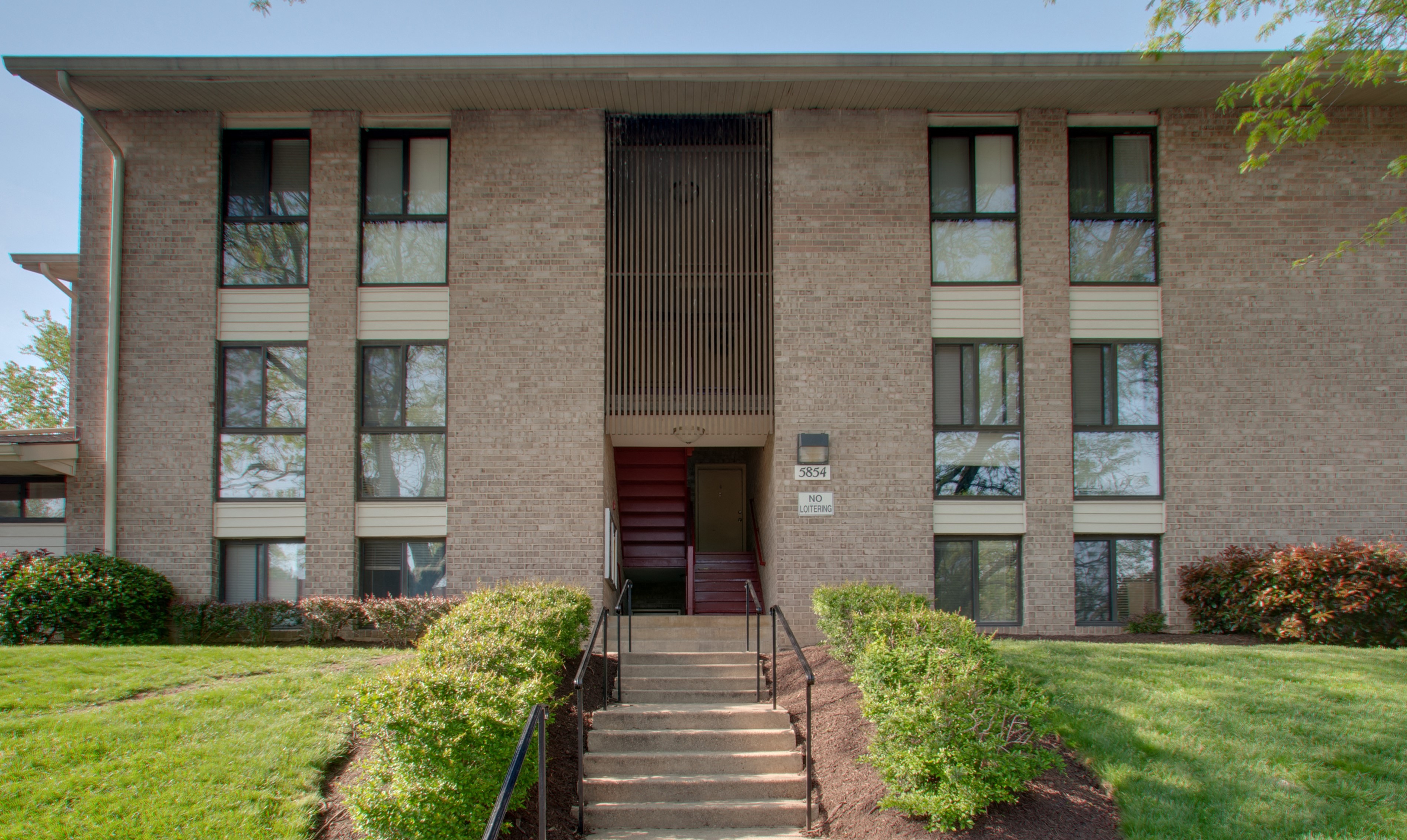 the front of a building with stairs in front of it