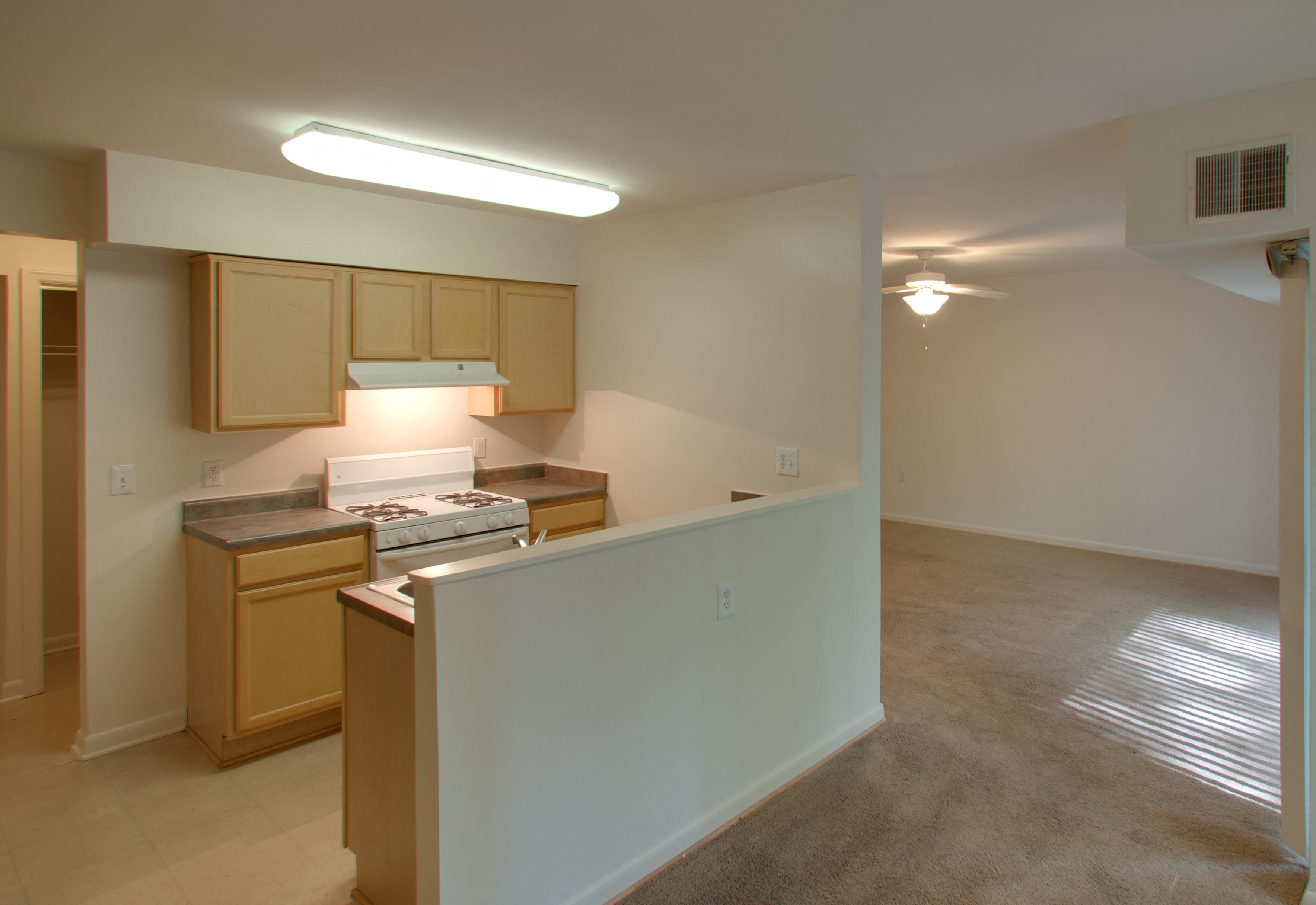 a kitchen and living room in an empty apartment