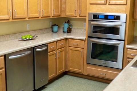 a kitchen with stainless steel appliances and wooden cabinets