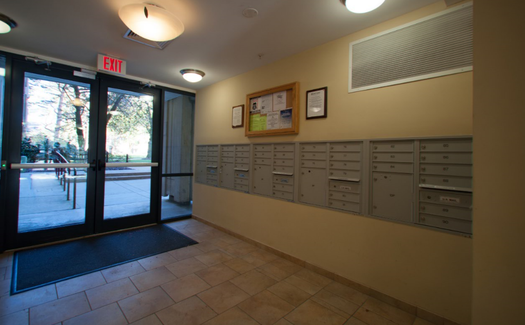 a locker room in a gym with a door to a patio