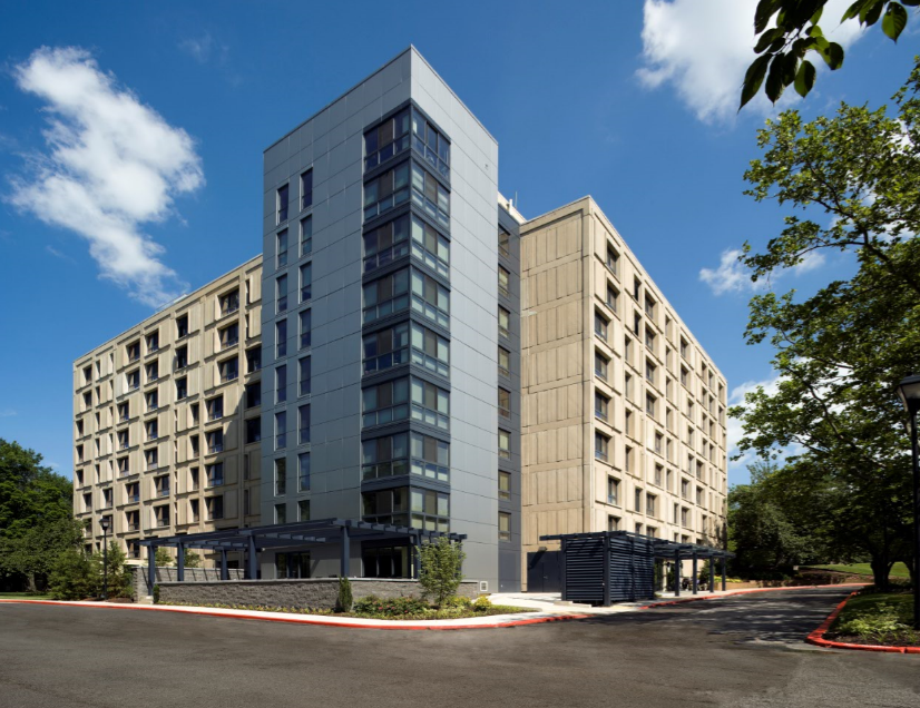 a rendering of a large apartment building on the corner of a street