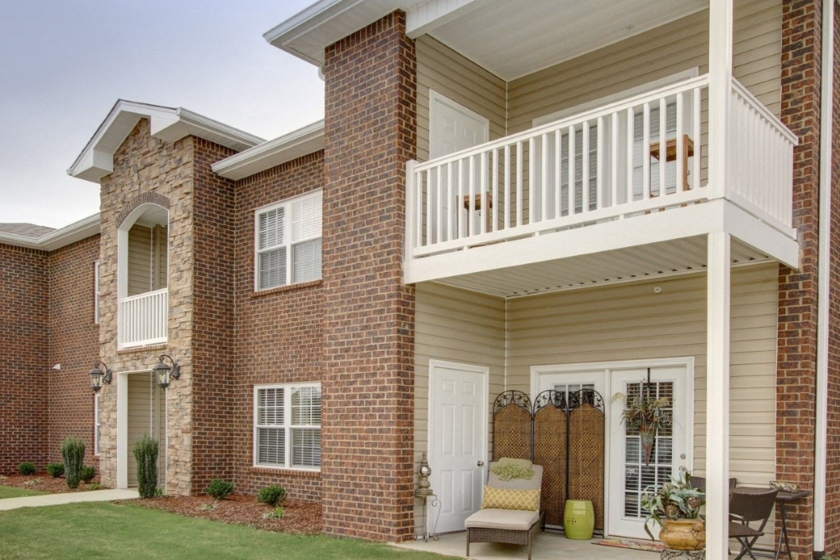 the outlook of a brick house with a balcony