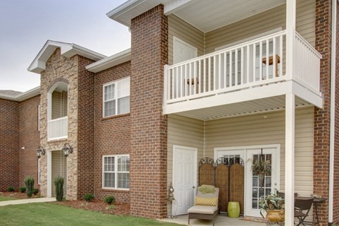 the outlook of a brick house with a balcony