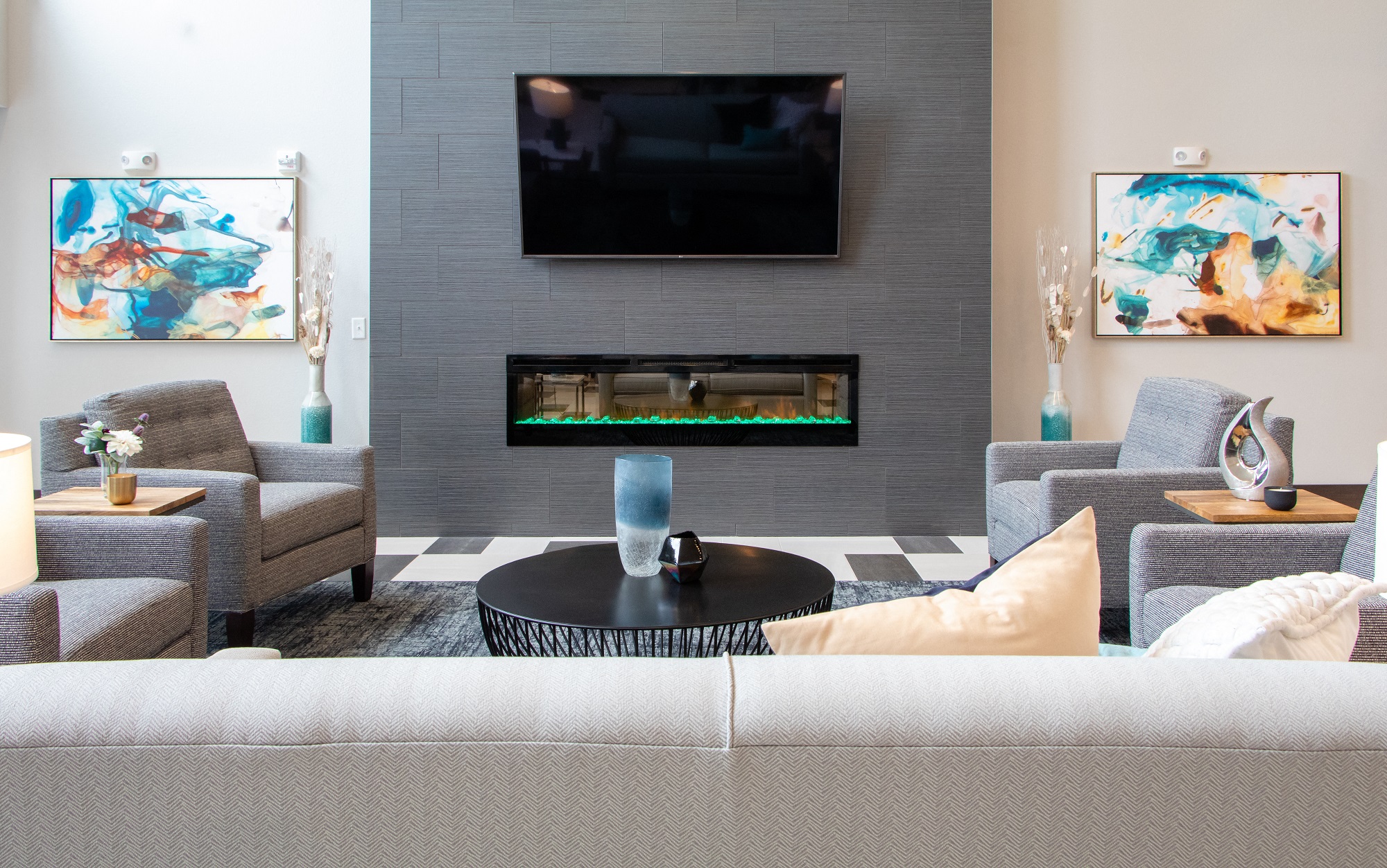 a living room with a couch and chairs and a fireplace