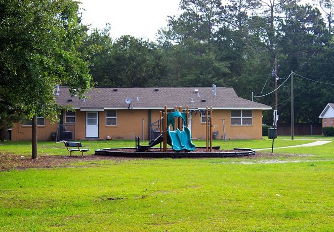 a playground in a park in front of a house