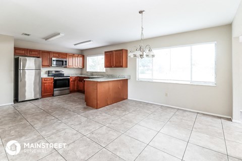 a large kitchen with wood cabinets and stainless steel appliances