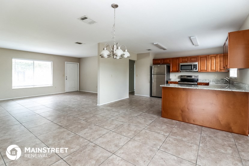 a kitchen with wood cabinets and stainless steel appliances