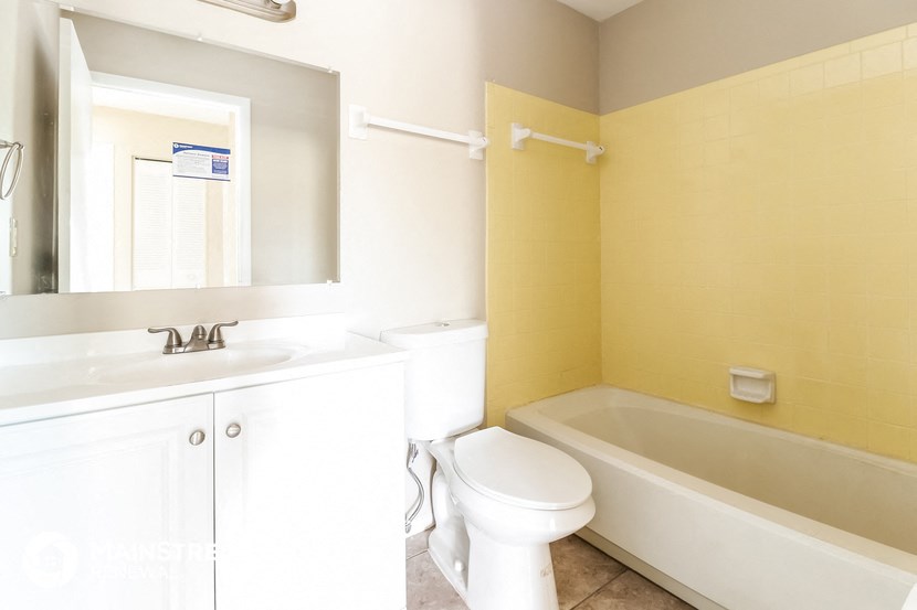 a bathroom with a sink toilet and a bath tub