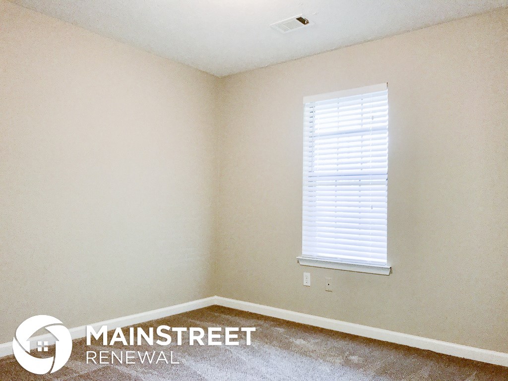 a small room with white walls and a window