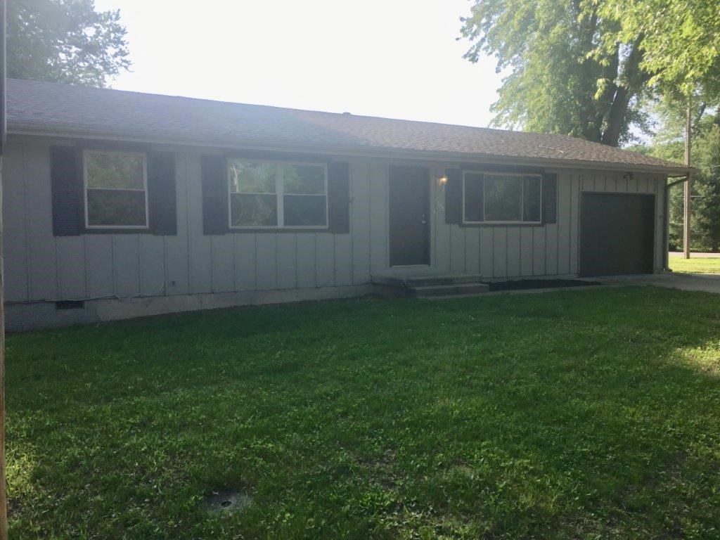 a white house with a lawn in front of it