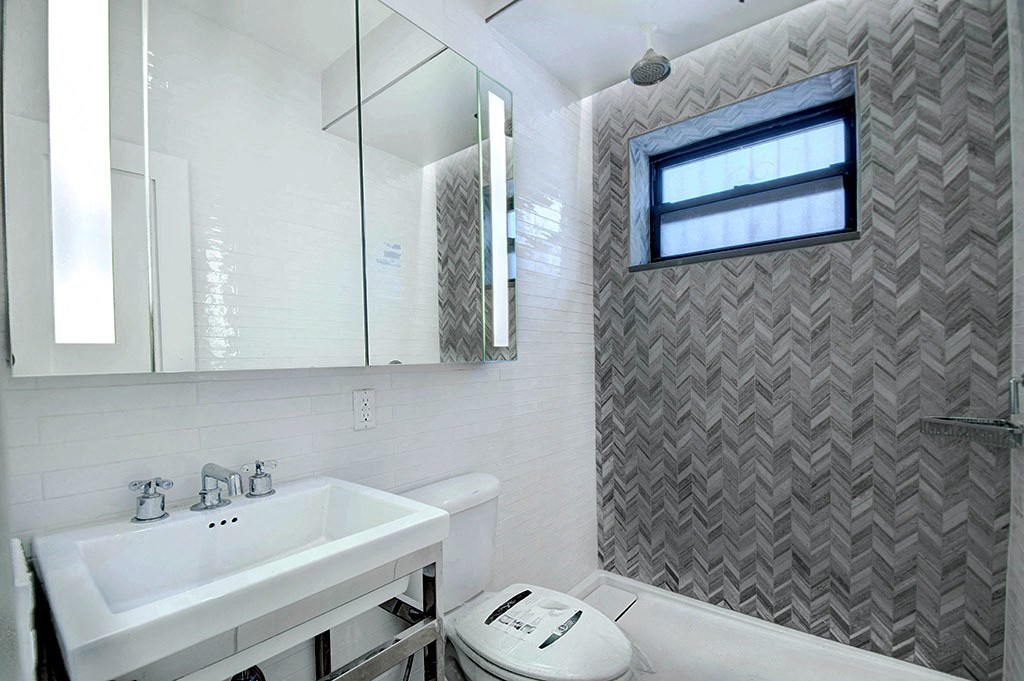 a white bathroom with a sink and a toilet