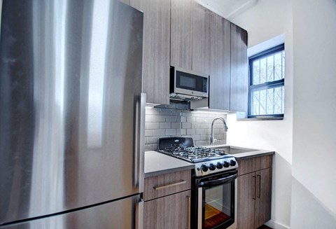 a kitchen with a stove and a refrigerator