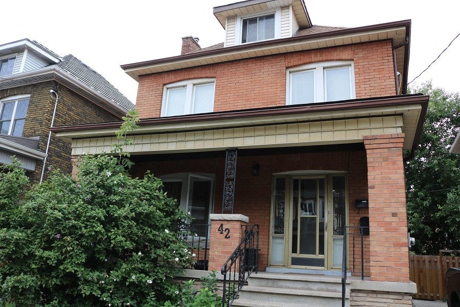 a brick house with a front door and steps