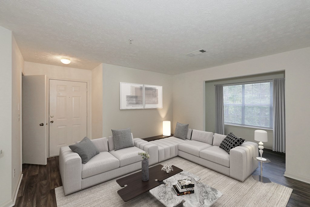 the living room of a house with a white couch and a table