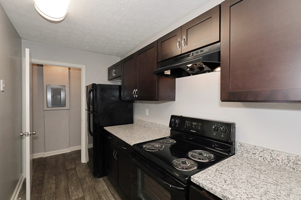 a kitchen with black appliances and granite counter tops
