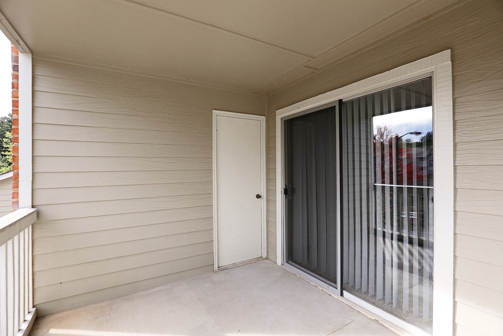 the entrance to a home with a sliding door to a patio