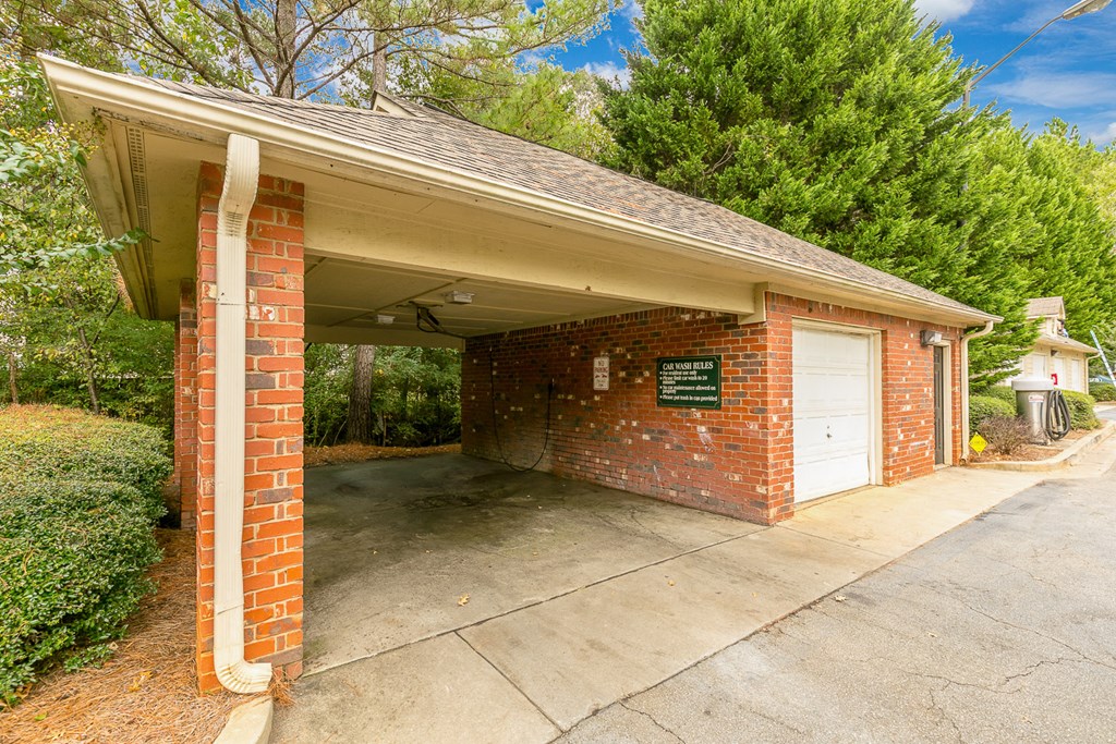 a small brick parking garage with a white door