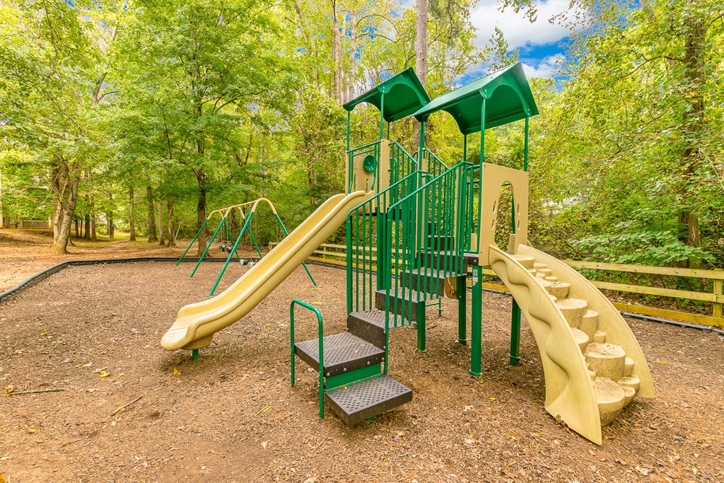 a playground with a slide and other toys in a park