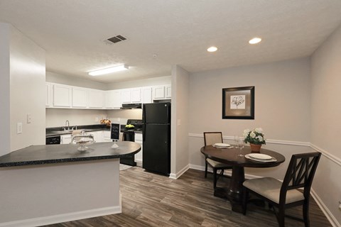 a kitchen and dining area with a table and chairs
