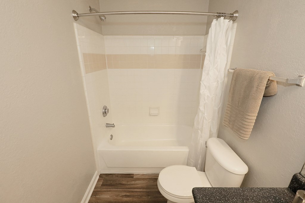 a small bathroom with a toilet and a tub