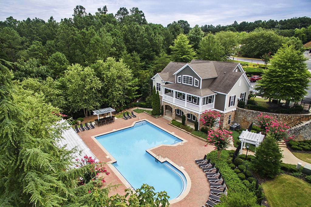 a large yard with a pool and a house