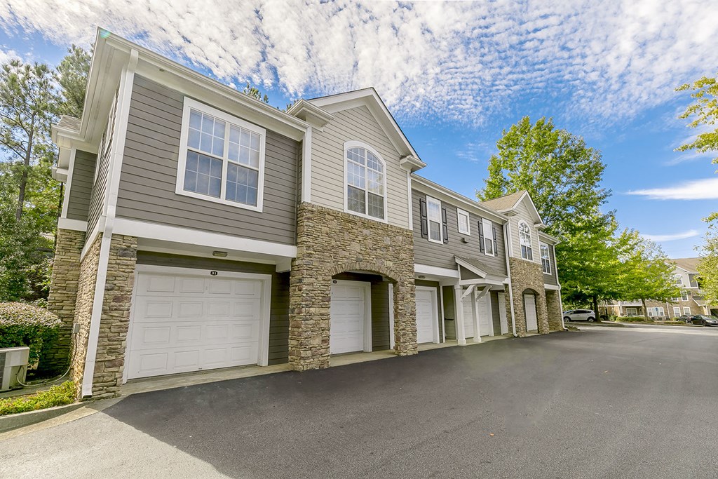 a street view of a house with white garage doors