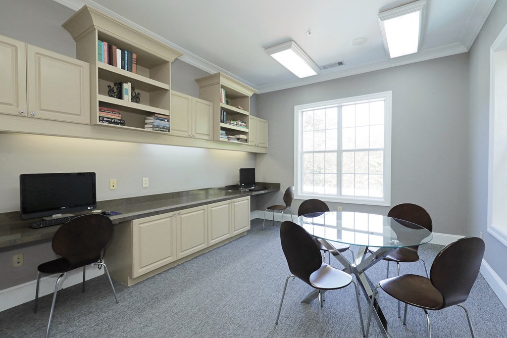 a conference room with a table and chairs and a tv