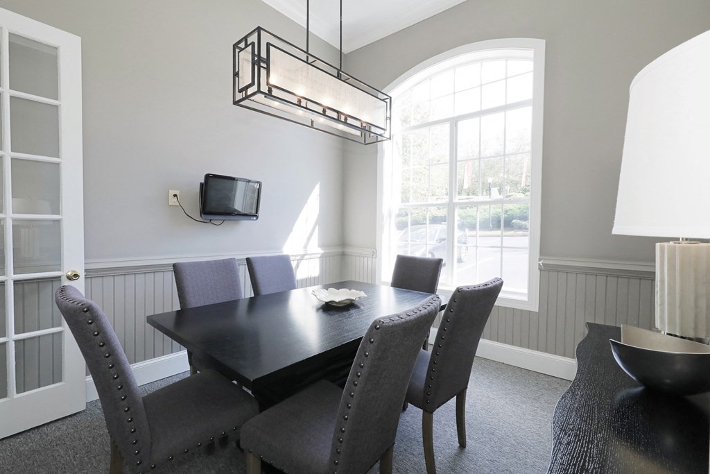 a dining room with a table and chairs and a tv