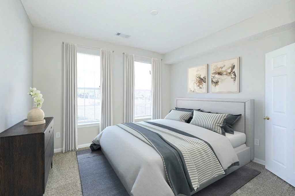 a bedroom with a bed and two windows