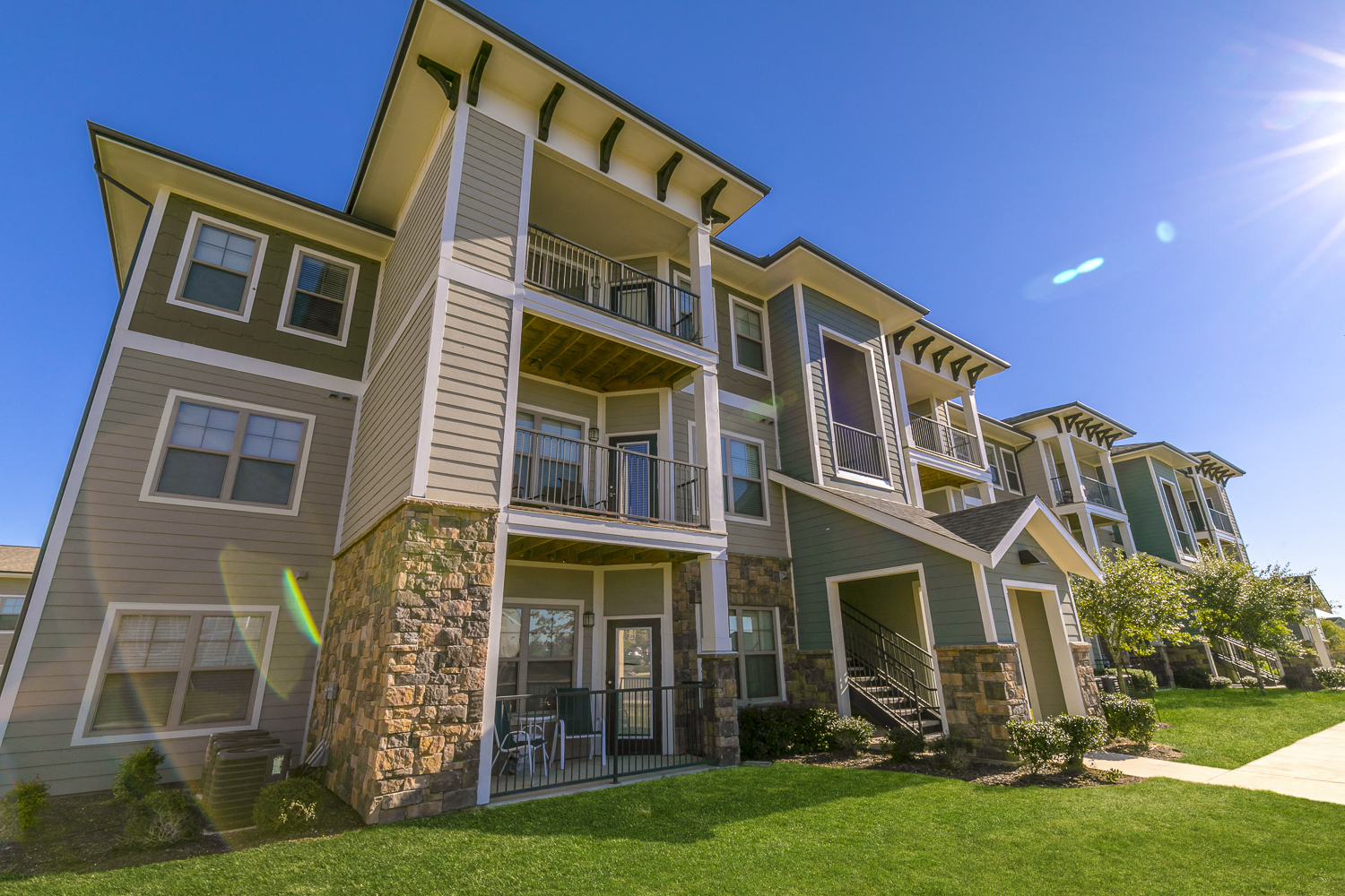 a row of apartment buildings on a sunny day