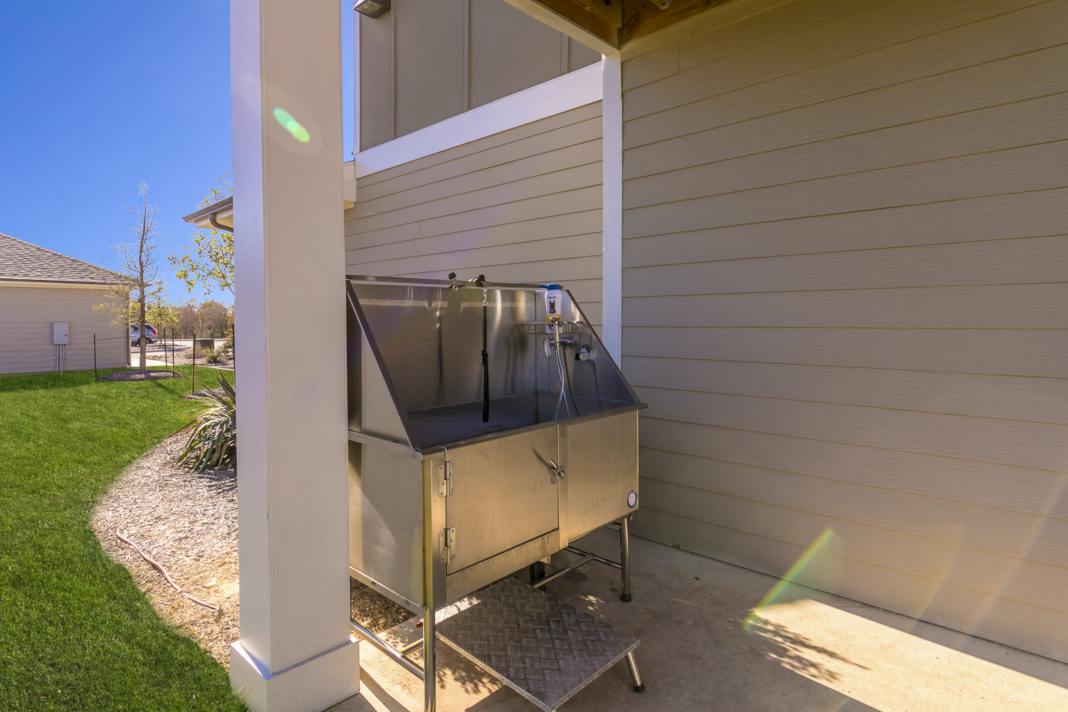a stainless steel grill on the side of a house