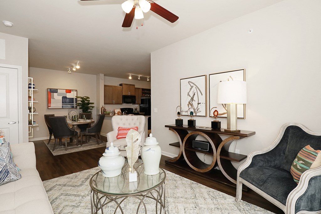 a living room with couches and a glass table