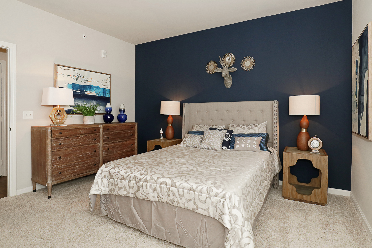 a bedroom with a bed and a blue accent wall