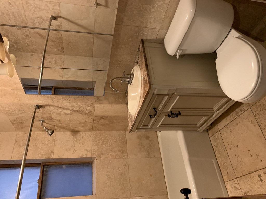 a bathroom with a toilet and a sink and a shower