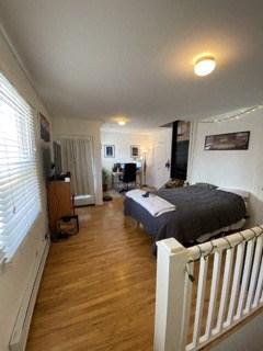 a bedroom with a bed and a white railing