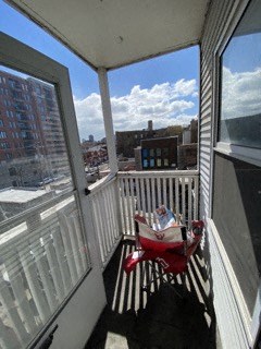 a balcony with a table and a chair on it