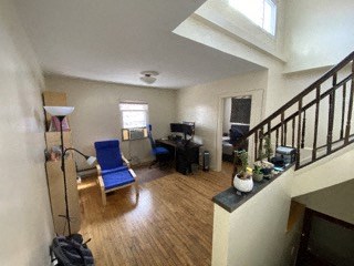 a living room with a staircase and a blue chair