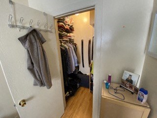 a room with a closet and a dresser in it